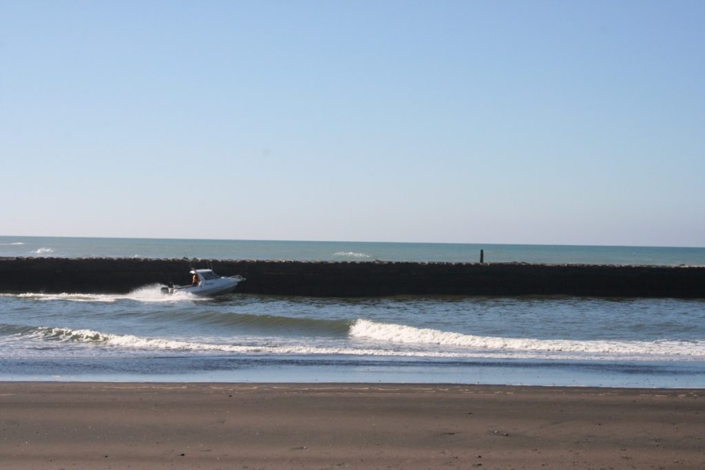 Boat going out on Patea River