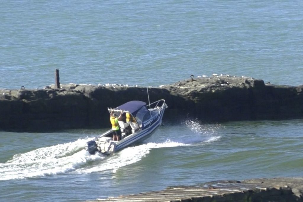 Boat going over Patea river bar