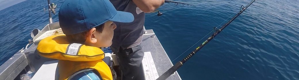 Young child fishing on boat at Pata